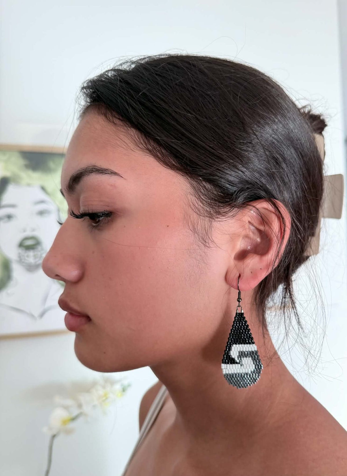 Hori.Inc Tino beaded earrings in black, worn, side view showing size